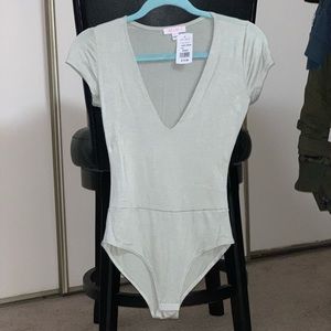 A’gaci low v-neck body suit size S